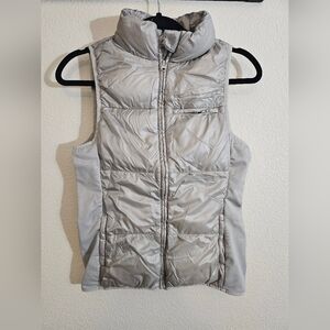 Fabletics Elliot Packable Puffer Vest in a metallic silver or ash color